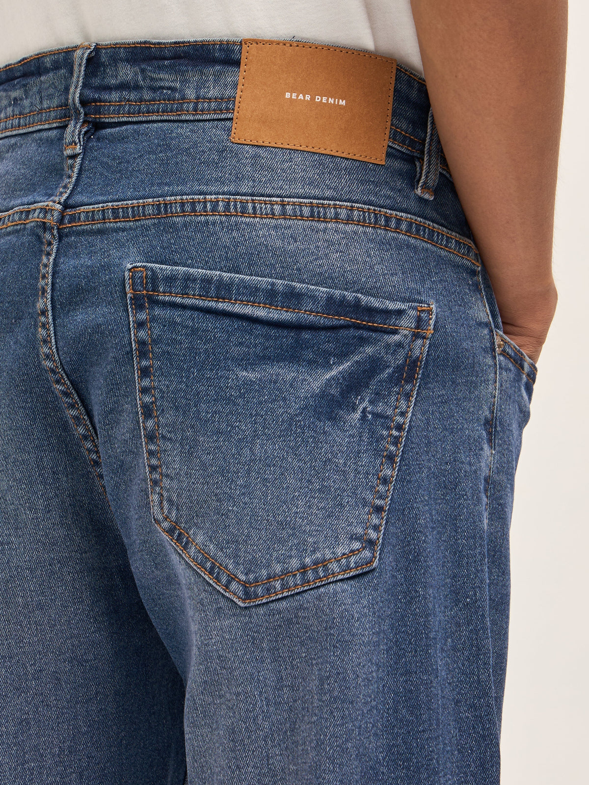 Mid Blue Mid-Rise Slim Fit Jeans with Lightly distressed